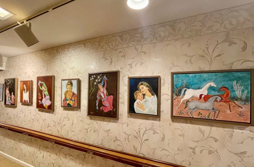 Local Artist Makes Rich Cultural Experience Possible for Juniper Residents at Brookline (hallway with artwork)