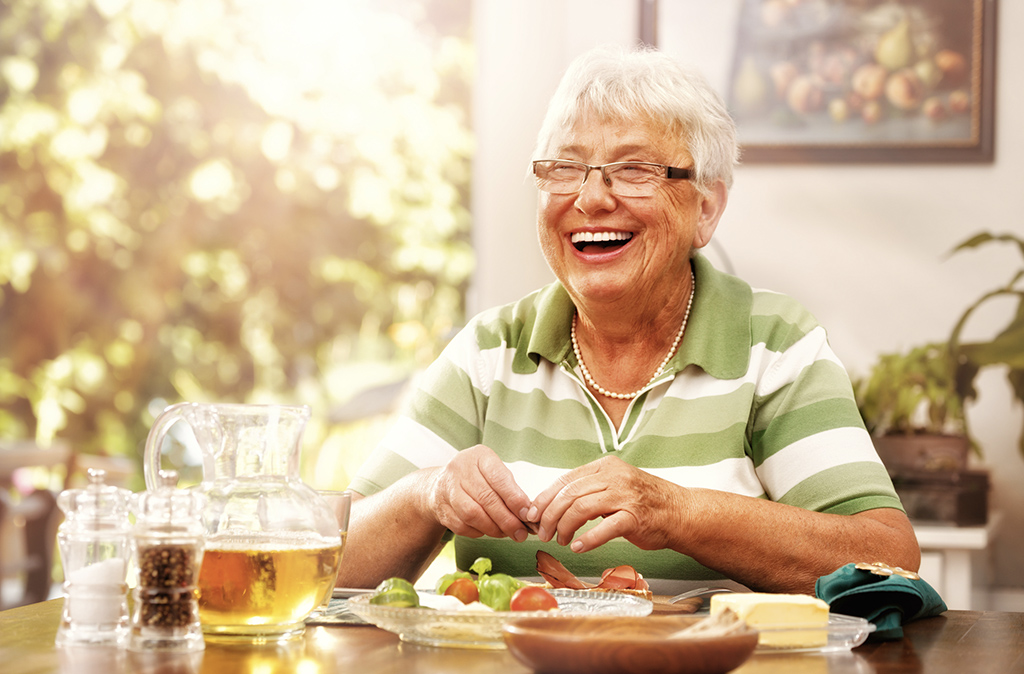 4 Ways to Offset the Cost of Senior Living with senior woman at table