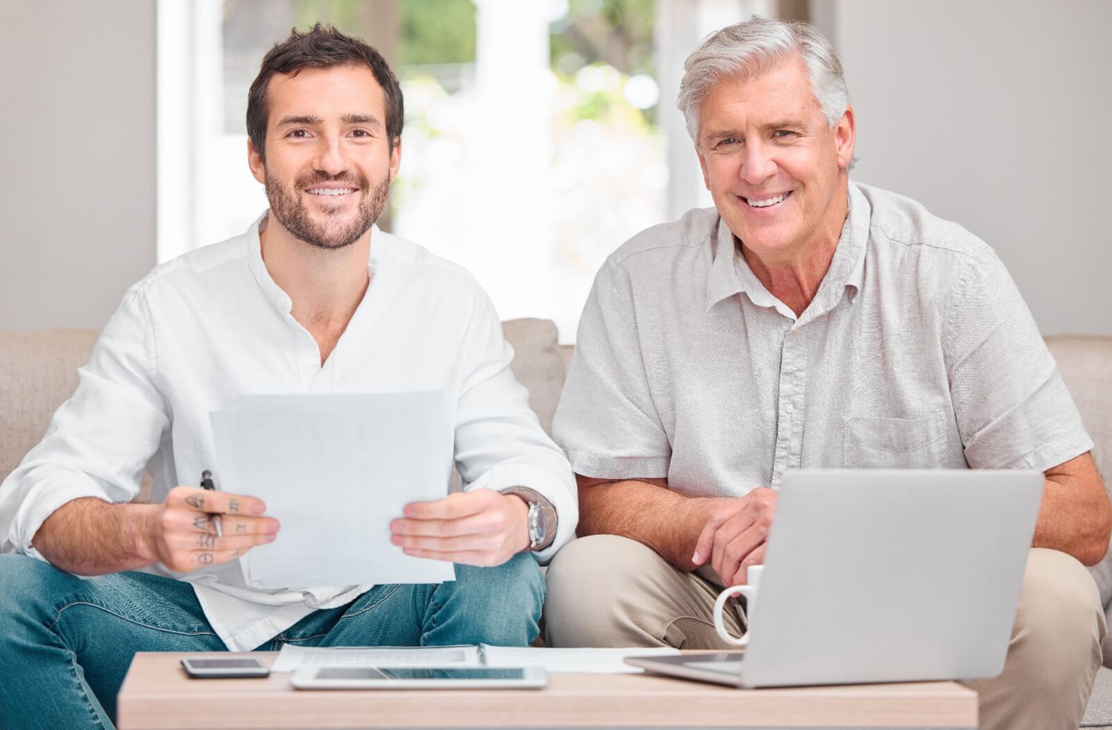 An adult son assisting his elderly father with household finances, as part of managing affairs under guardianship considerations