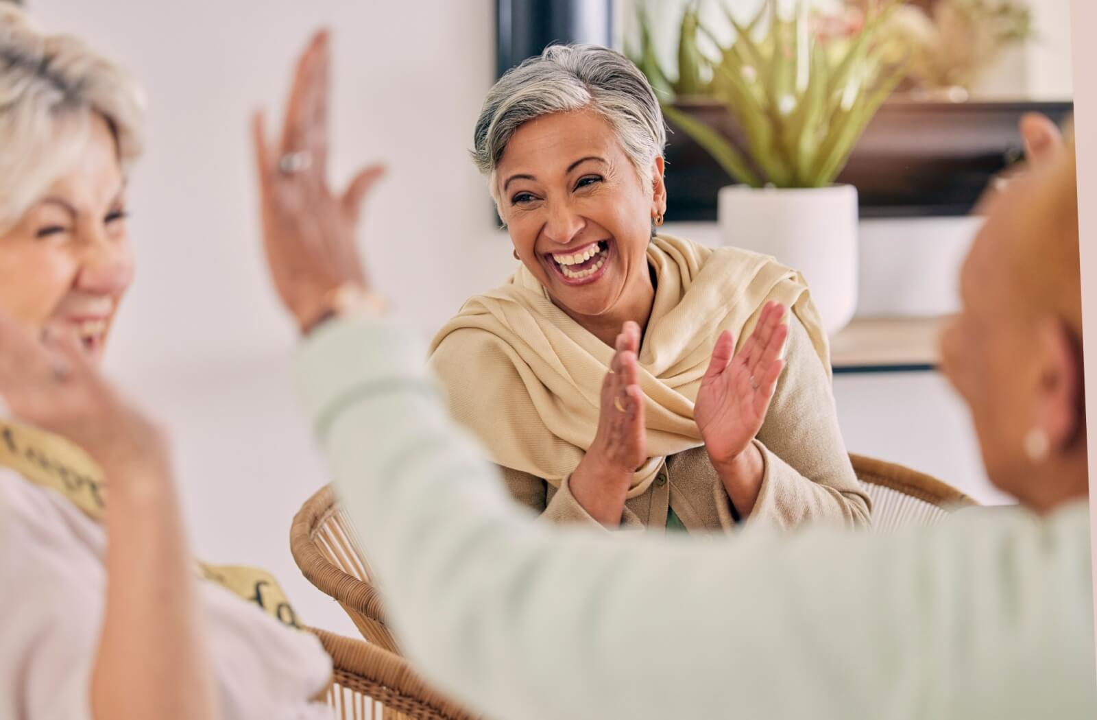 A group of older adults enjoying social time together in an independent living community.