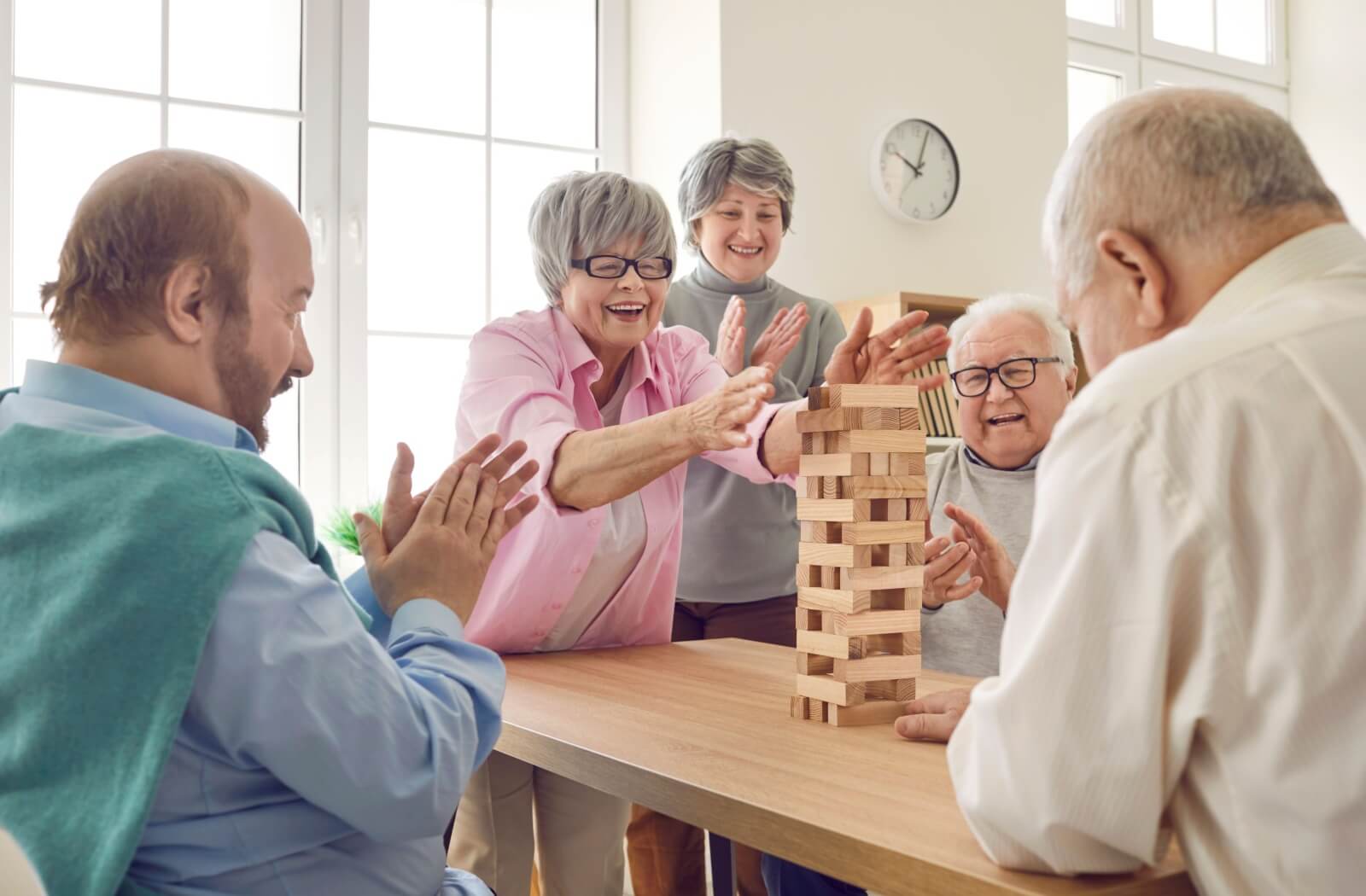 A group of older adults playing a game, promoting social interaction and mental wellness.