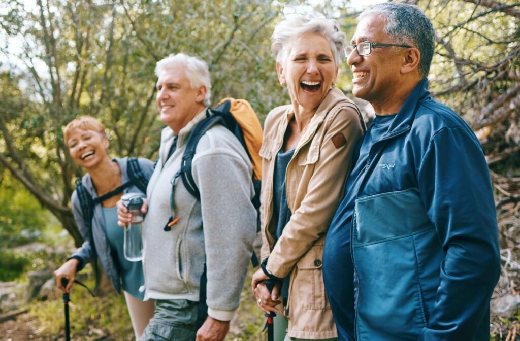 Group of seniors laughing and enjoying a hike together in the outdoors.