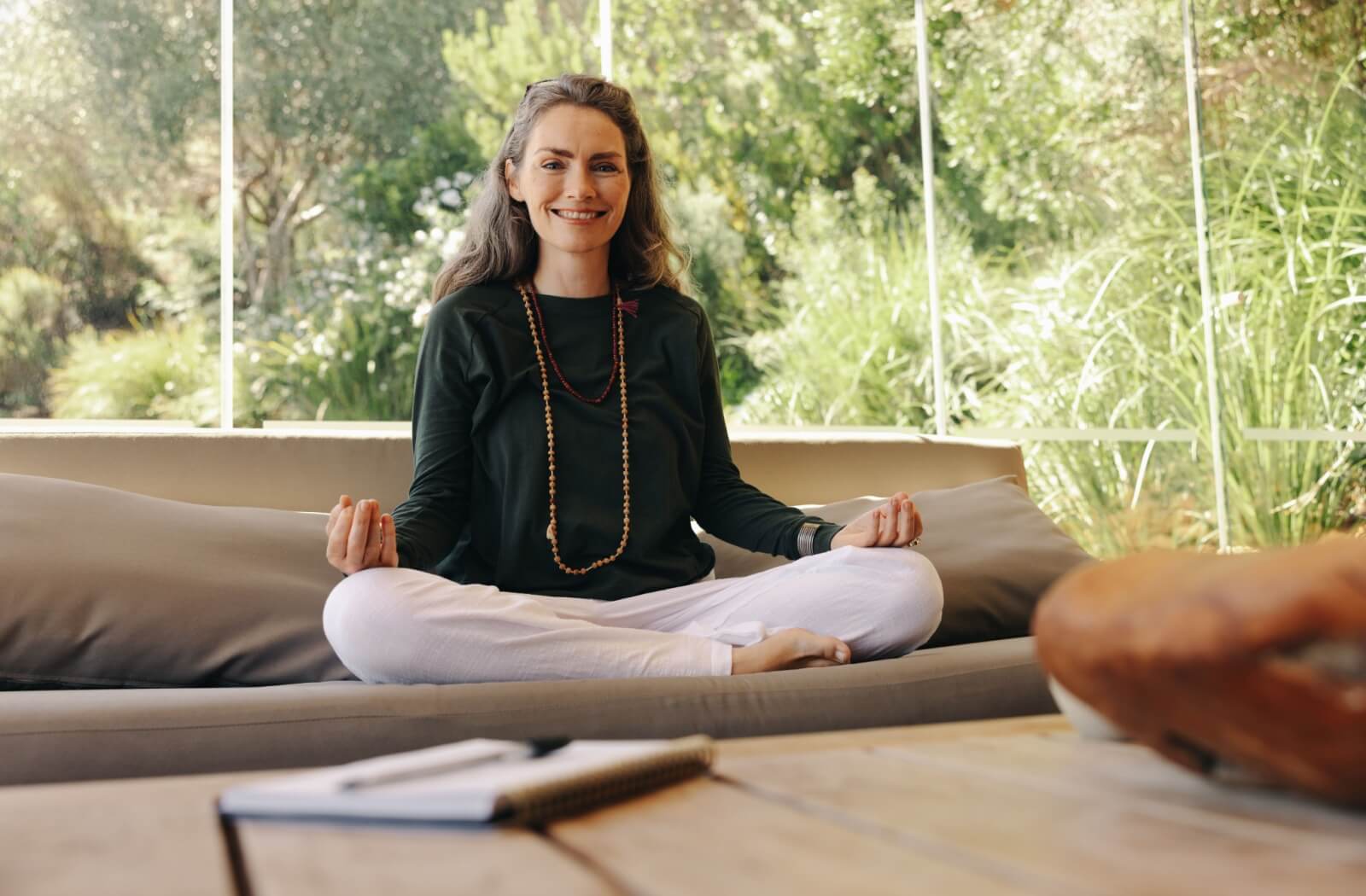 A mature woman participates in a holistic approach to well-being through mindful meditation.