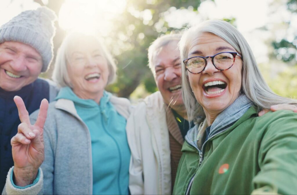 A happy group of older adults smile and pose for the camera.