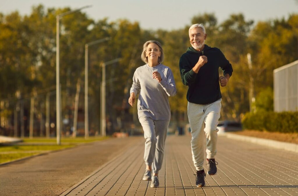 Older adult couple goes for a run together.