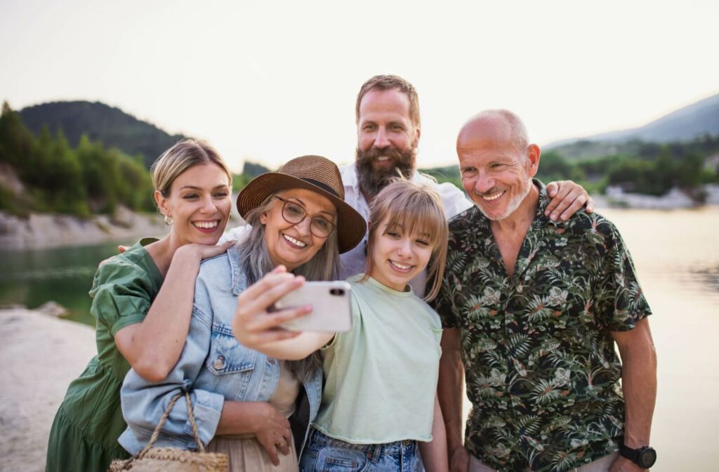 Multigenerational family taking a group selfie while enjoying their vacation.