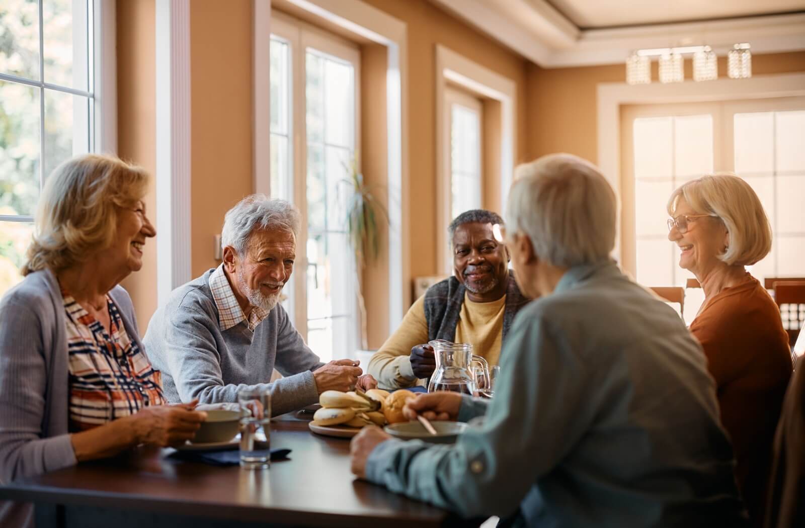 A group of older adults enjoy breakfast together.
