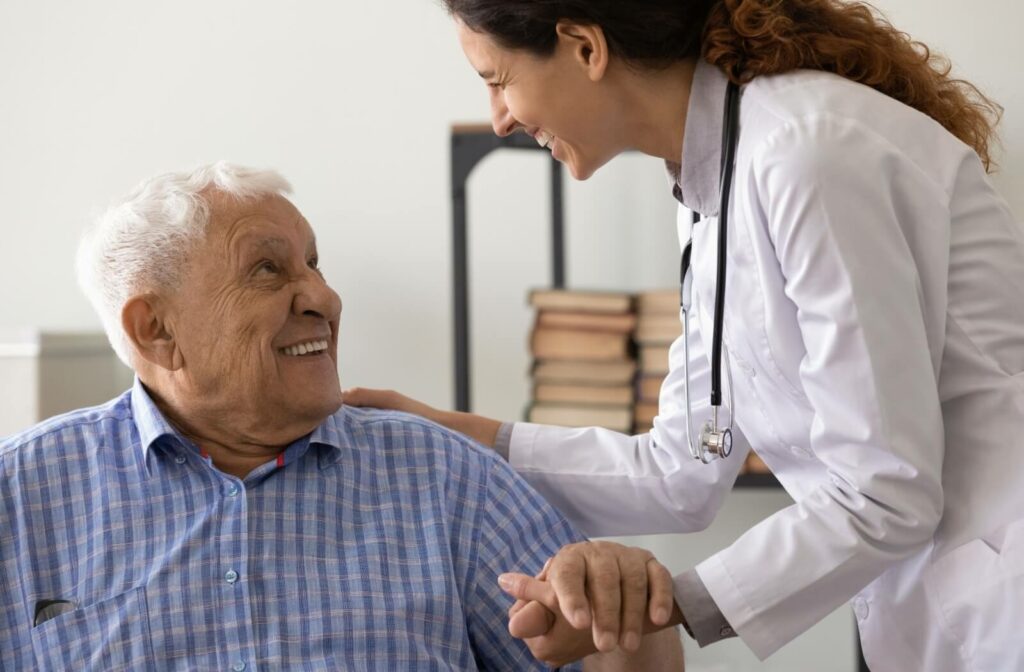 A senior smiles up at their doctor after undergoing a cognitive health assessment and to make sure they don't have dementia.