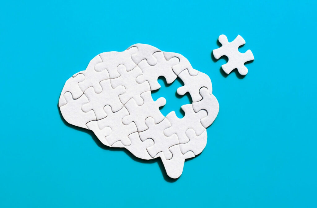 A brain-shaped puzzle sits with a missing piece, symbolizing the changes an older adult has as they experience memory issues.