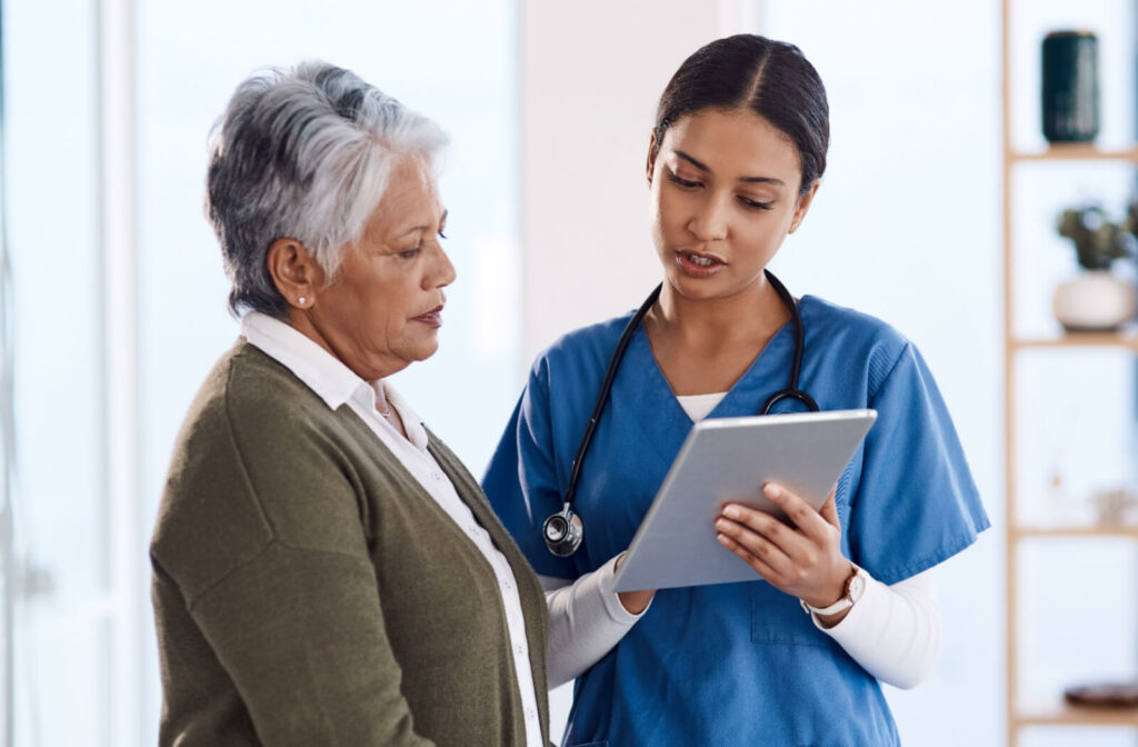 A nurse showing a resident in assisted living the results of their most previous healthcare checkup.