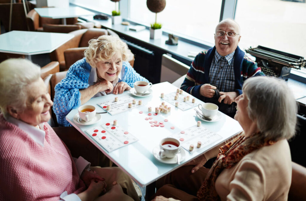 A group of seniors playing a board game in a retirement home.