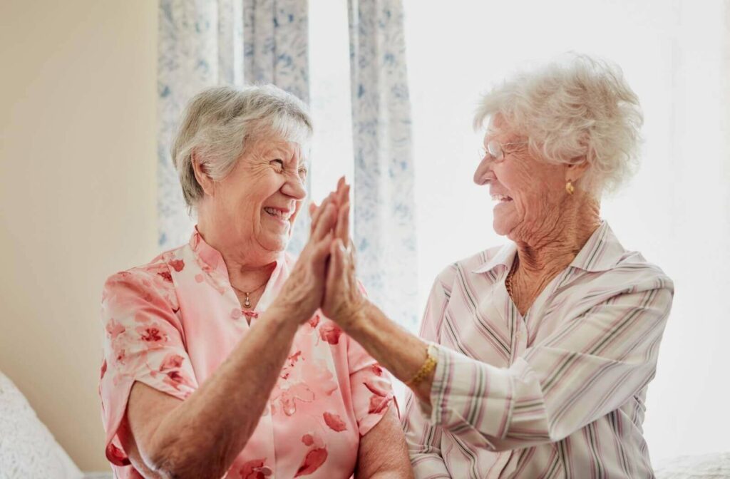 seniors smiling to each other and giving a high five